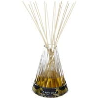 Clear glass Ortigia diffuser with golden liquid, black and gold label, and multiple thin reeds.