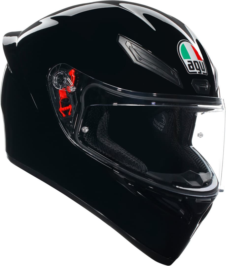 Solid black full face helmet with a glossy finish, featuring a clear visor, ventilation vents, and the AGV logo in front, designed for comfort and safety.