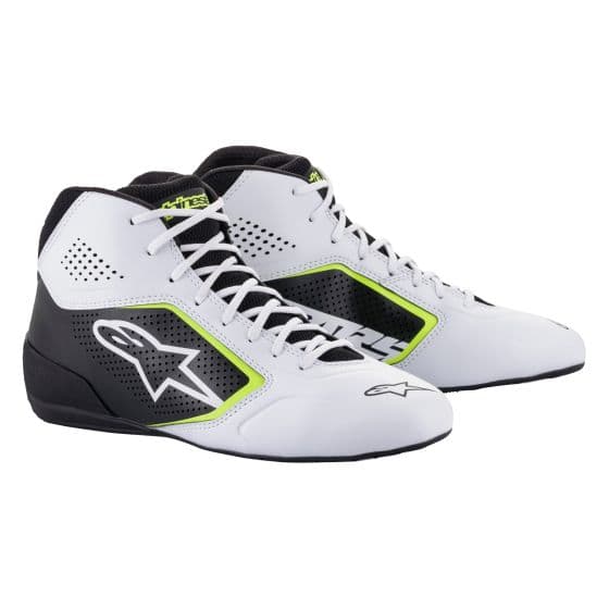 Black and white kart boots with fluro yellow accents, featuring a sleek design, breathable perforations, and a lace-up closure, size UK 8 / EUR 42 by Alpinestars.