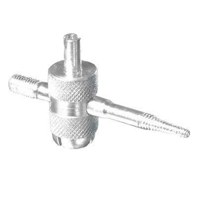 Silver metal 4-way valve tool featuring a knurled grip, two tapered ends for valve cores, and a central body for easy handling, designed for bicycle maintenance.