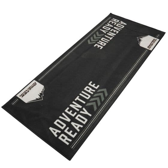 Black carpet with "ADVENTURE READY" text in bold white letters, featuring a mountain graphic and grey chevron designs, made from durable, eco-friendly material.