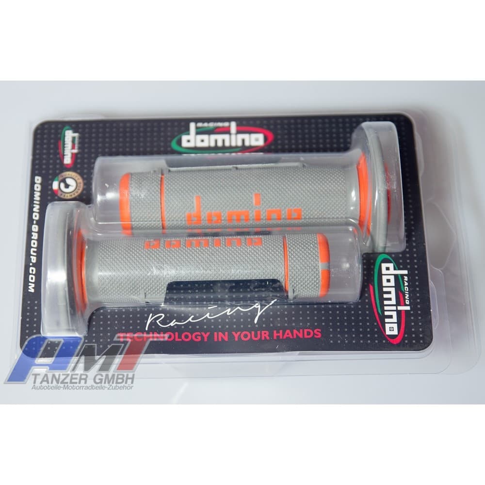Two-tone gray and orange rubber grips with a full diamond texture, featuring the "Domino" logo, packaged in clear plastic with a black backing.