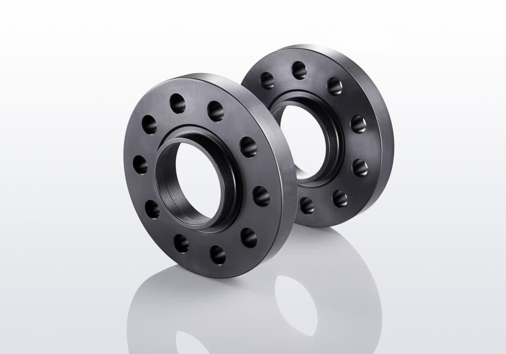 Two black aluminum track widening spacers, each 10mm thick, featuring five holes and designed to increase track width by 20mm per axle.