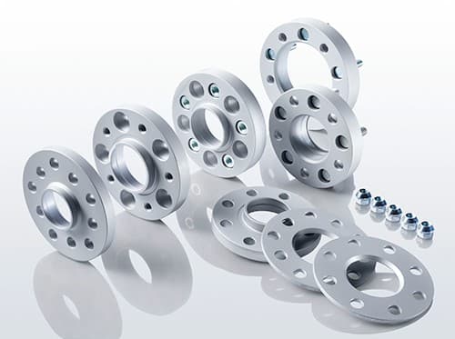 Silver aluminum track widening spacers with 12mm thickness, featuring five holes each, arranged in pairs, accompanied by small silver bolts.