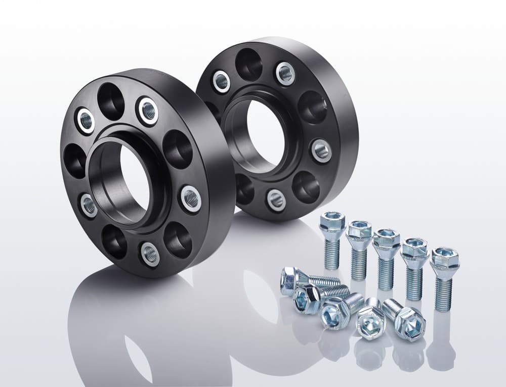 Black aluminum track widening spacers with five holes, accompanied by silver bolts and nuts, designed to widen track by 20mm per side, totaling 40mm per axle.
