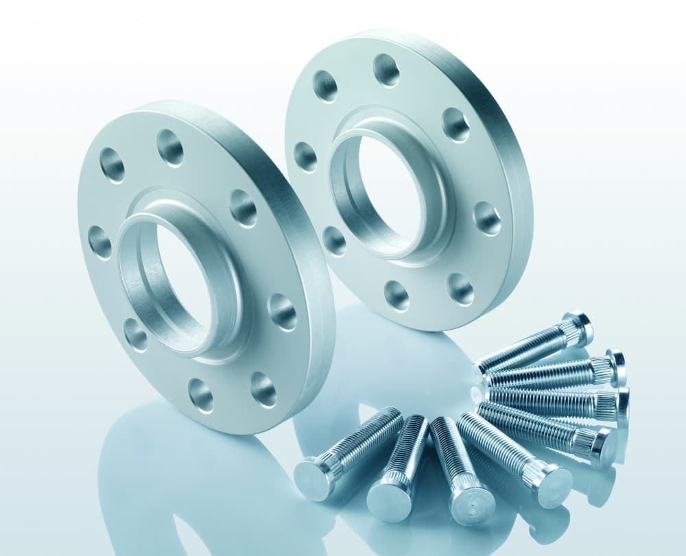 Silver aluminum track widening spacers with five holes each, accompanied by a set of silver bolts, designed to widen track by 20mm per side, totaling 40mm per axle.