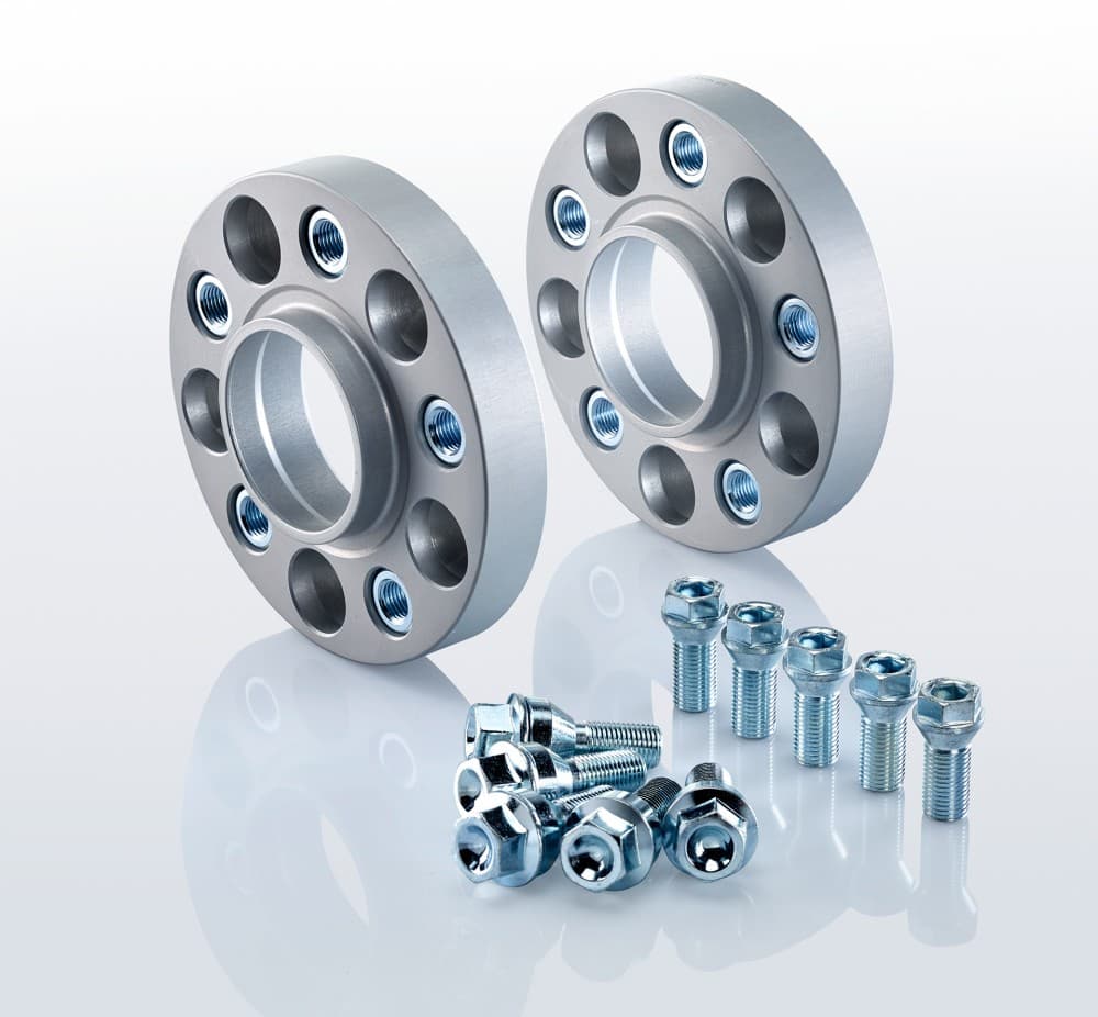 Silver aluminum track widening spacers with four holes each, 25mm thick, accompanied by a set of chrome-plated bolts and nuts for installation.
