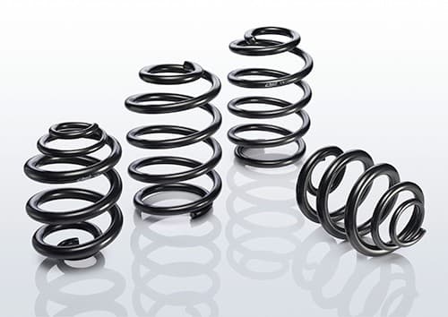 Black coil springs from the EIBACH E10-85-019-02-22 Suspension Kit, featuring a sleek, shiny finish and varying diameters for enhanced vehicle performance.