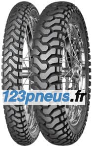 Black rubber motorcycle tires with a rugged tread pattern, featuring a mix of deep grooves and raised sections, designed for off-road and trail riding, mounted on metal spokes.
