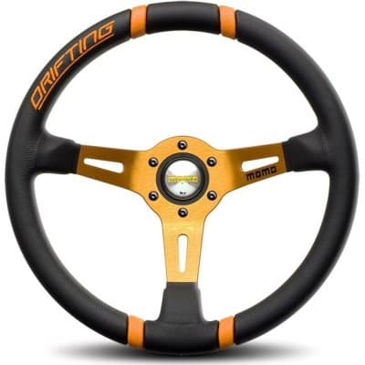 Black leather racing steering wheel with orange accents and "DRIFTING" text, featuring a gold anodized center hub and three-spoke design, Ø 35 cm.