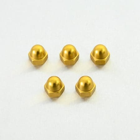 Five gold alloy dome nuts, M10 x 1.25mm, featuring a shiny, smooth surface and hexagonal base, arranged on a light background.