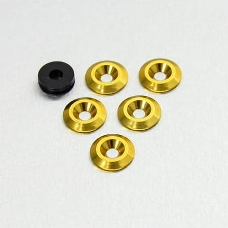 Five gold countersunk alloy washers with a shiny finish, sized M6 x 19mm, accompanied by one black washer, all displayed on a light gray background.