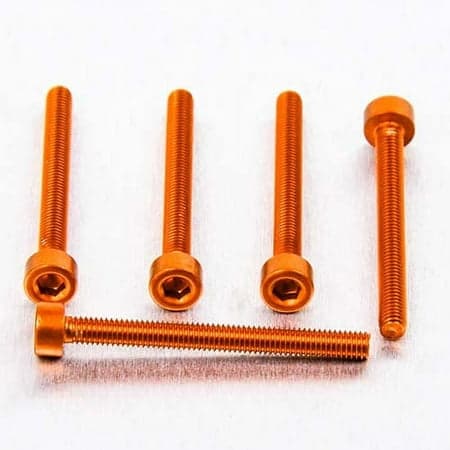 Five orange alloy parallel Allen head bolts, each measuring M3 x 0.50mm x 30mm, showcasing a hexagonal socket for wrenching, arranged on a light surface.