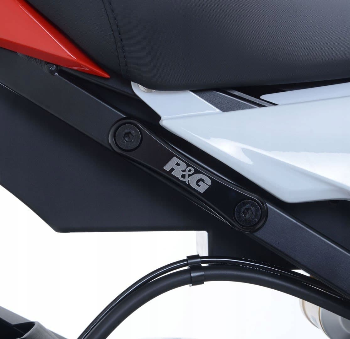 Black R&G motorcycle rear footrest blanking plate with a sleek design, featuring the R&G logo and metallic finish, mounted on a motorcycle frame.