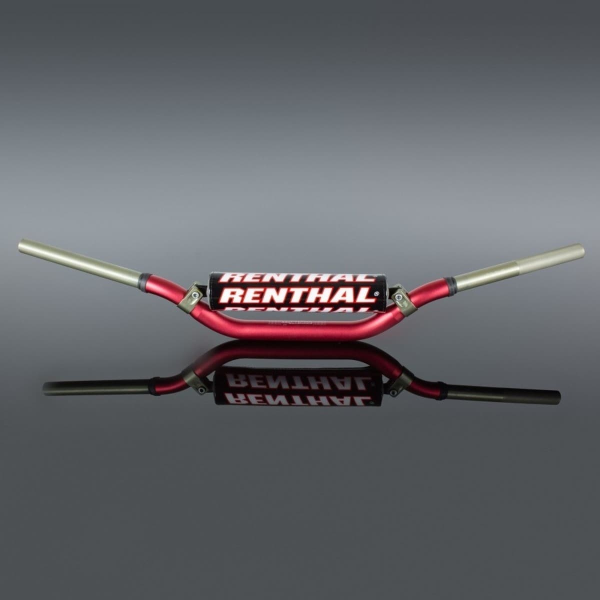 Red Renthal 996 Twinwall handlebars with a distinctive Villopoto/Stewart bend, featuring aluminum construction and a glossy finish, displayed against a reflective surface.