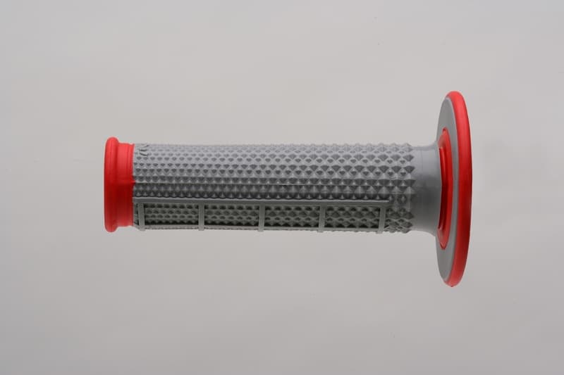 Gray rubber MX grip with a half waffle pattern and red end caps, designed for enhanced grip and control in motocross applications.