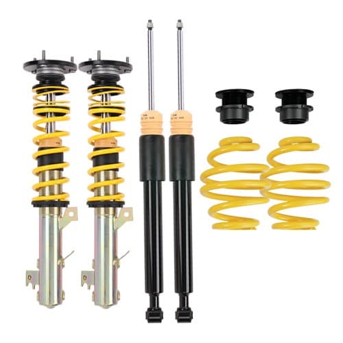 ST Suspension ST XTA Coilover Kit featuring yellow springs, black shock absorbers, adjustable top mounts, and components for lowering front and rear by 30-50mm.