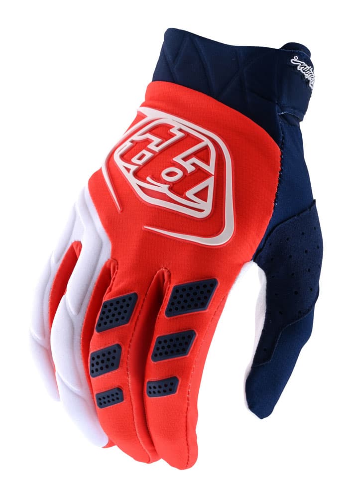 Orange and navy textile gloves with a prominent white logo, featuring padded fingers, ventilation holes, and a snug fit, designed for performance and comfort.
