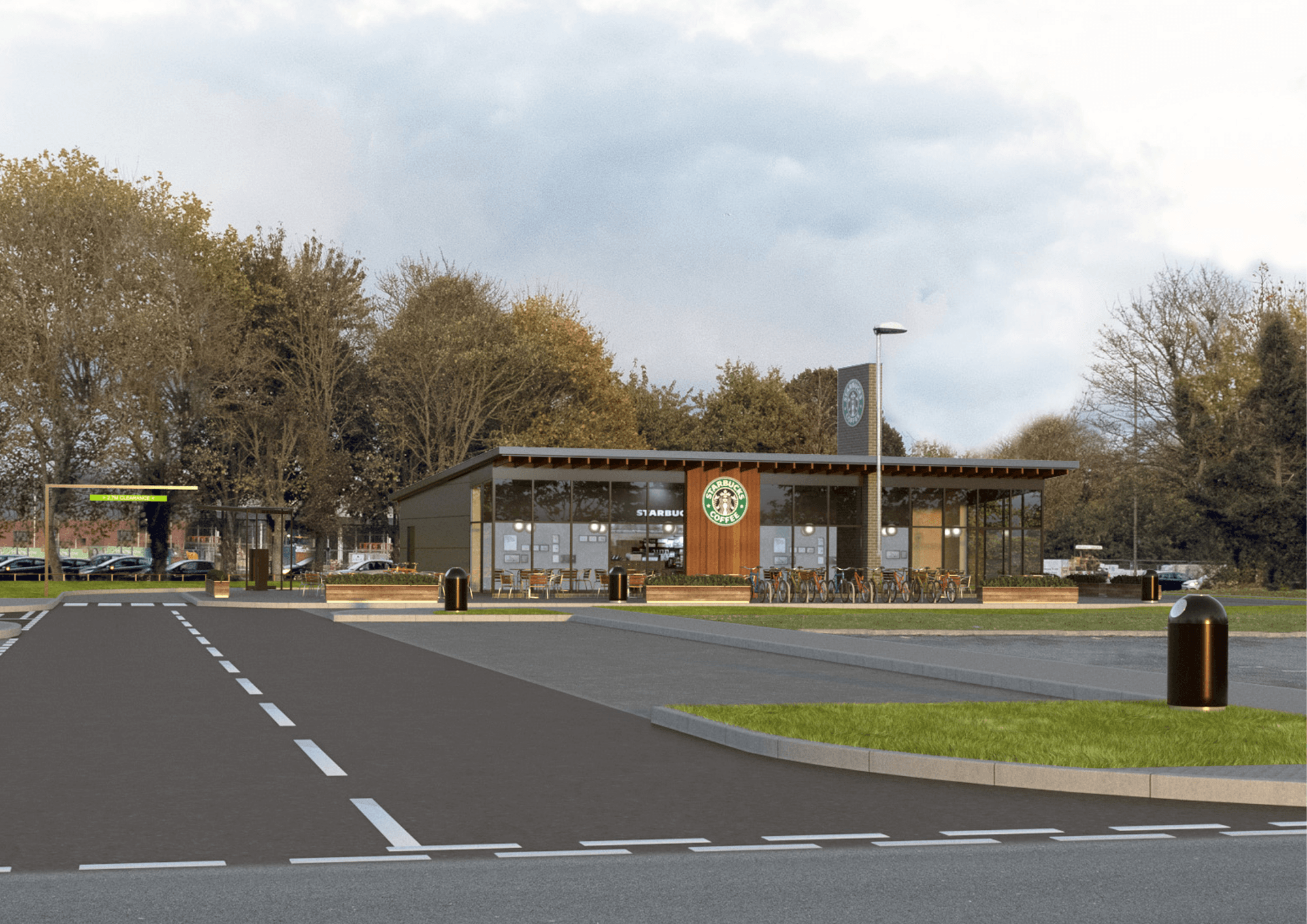 Modern drive-thru building with large windows, surrounded by trees and a paved parking area in Bradford.