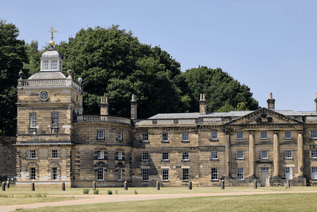 Restored South Tower at Wentworth Woodhouse, showcasing grand Palladian architecture against a lush green backdrop.