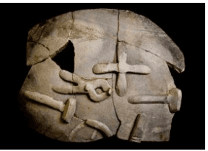 Ancient stone artifact with intricate carvings, showcasing historical significance at Malton Museum, Yorkshire.