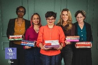Five women hold colorful books in front of a green backdrop, celebrating literary achievements and women's voices.