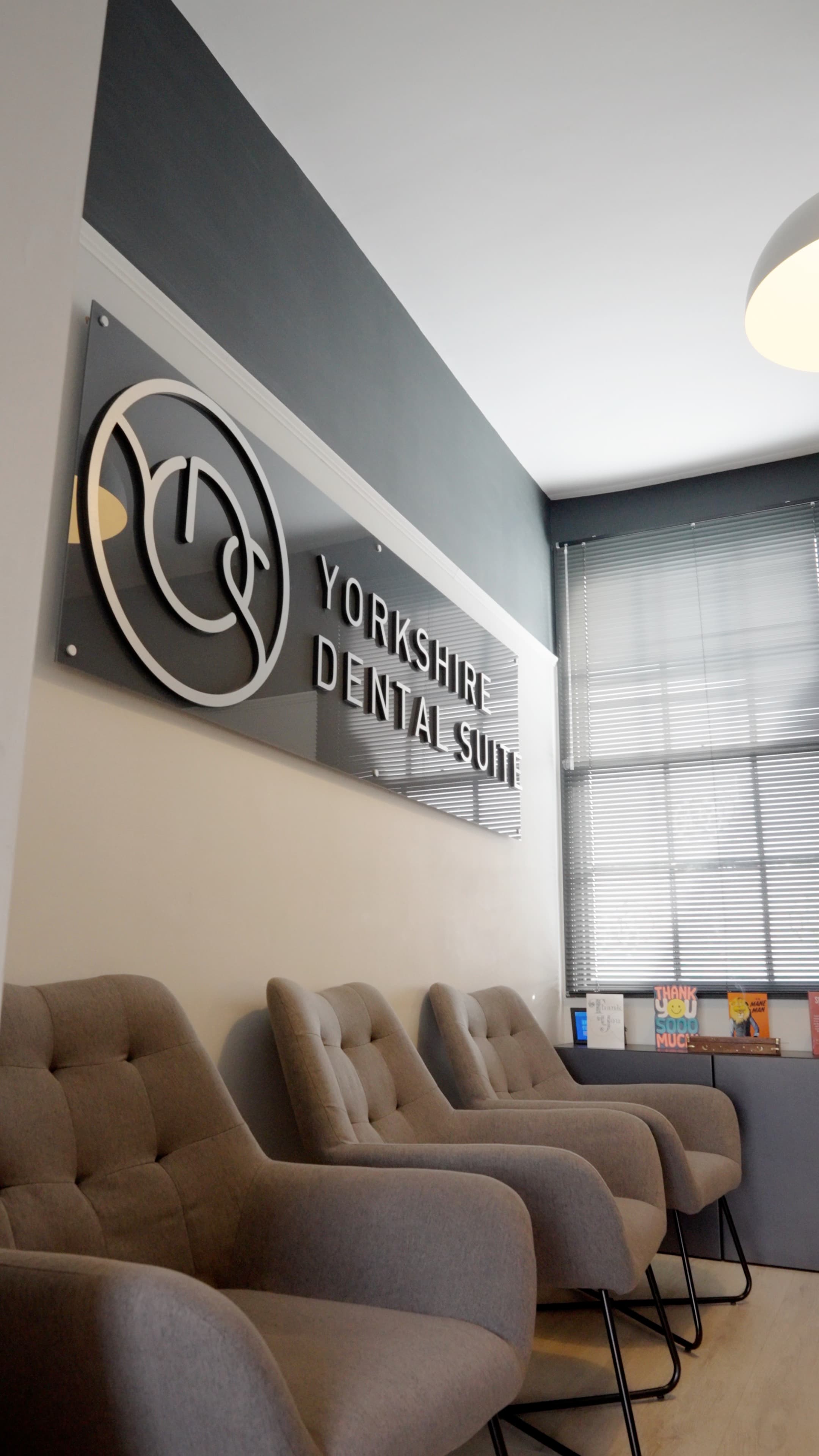 Modern dental clinic interior featuring the Yorkshire Dental Suite sign, stylish seating, and a welcoming atmosphere.