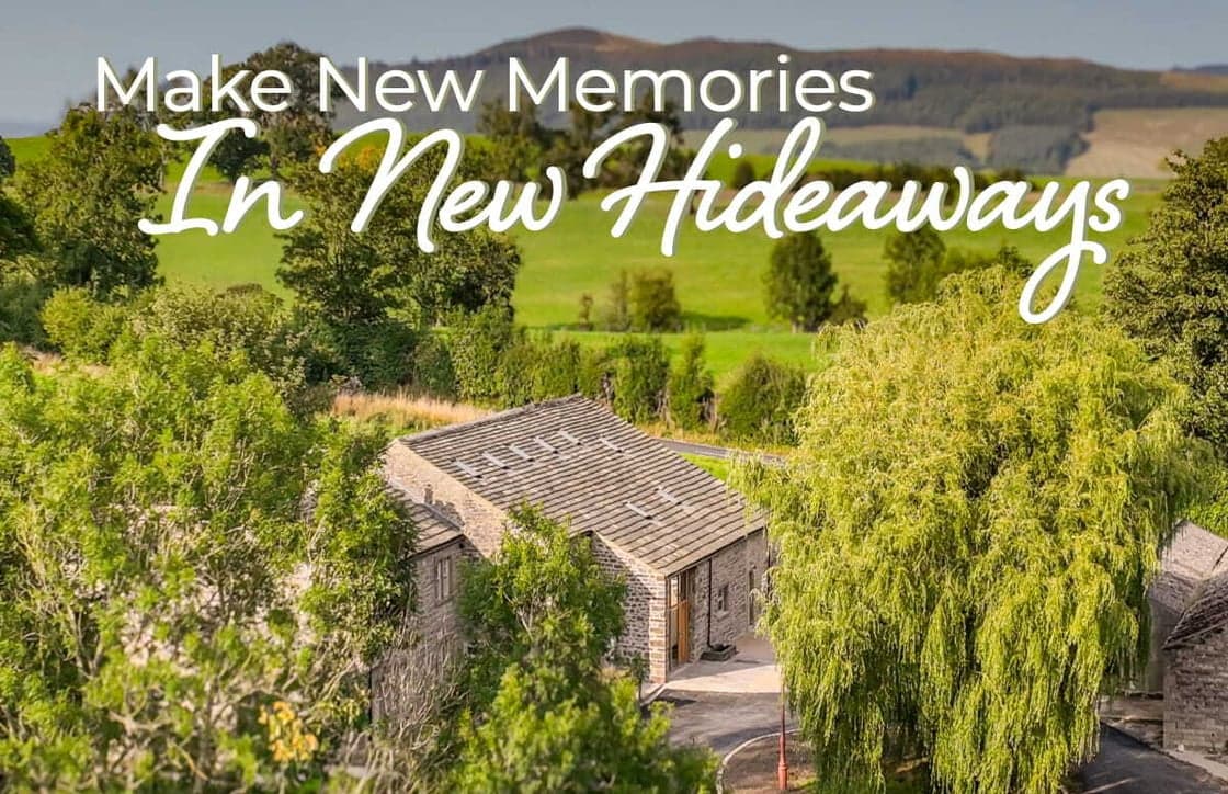 Stone cottage nestled among lush greenery, rolling hills in the background, inviting atmosphere for relaxation and exploration.