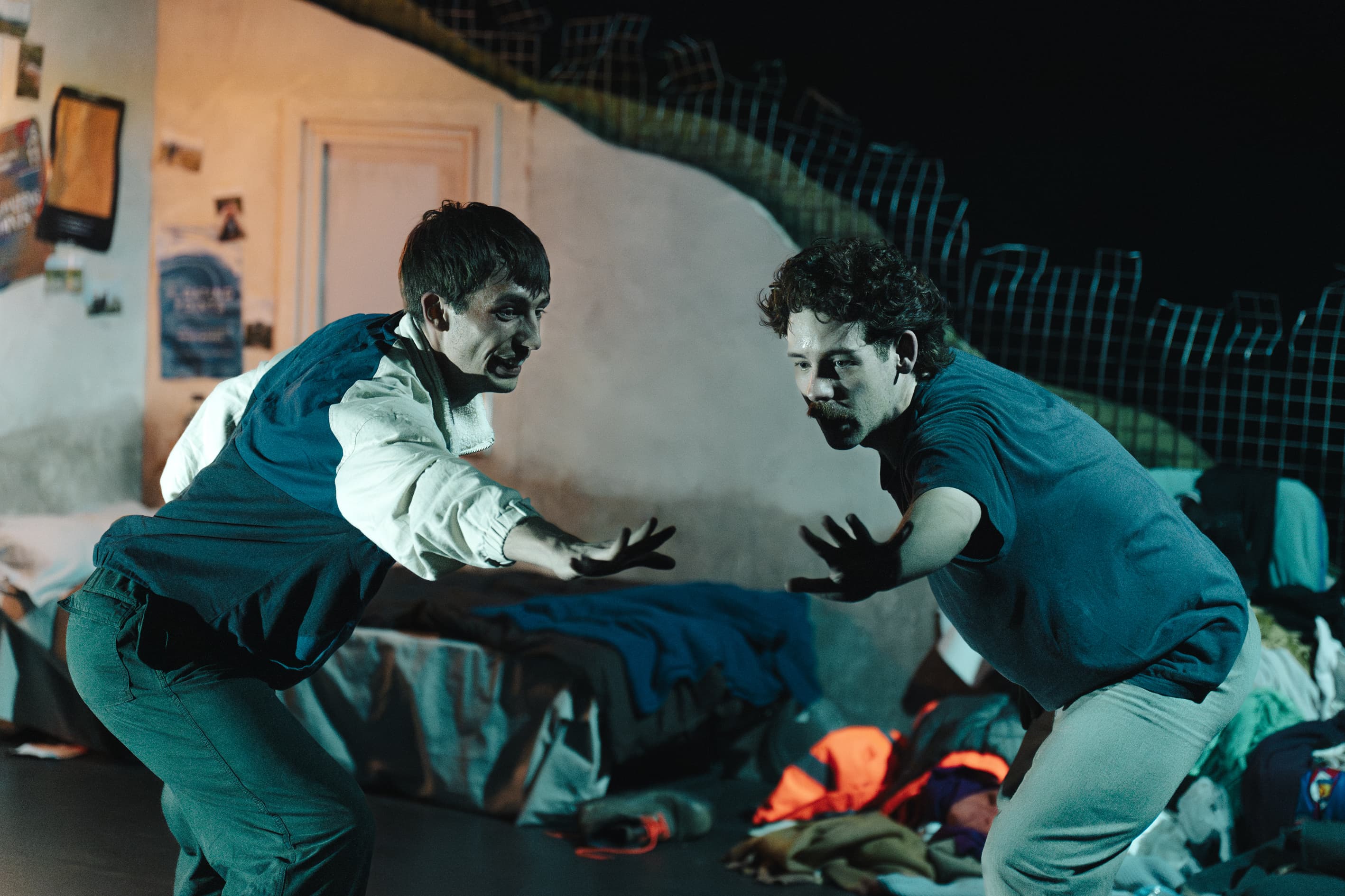 Two actors performing on stage with dramatic expressions