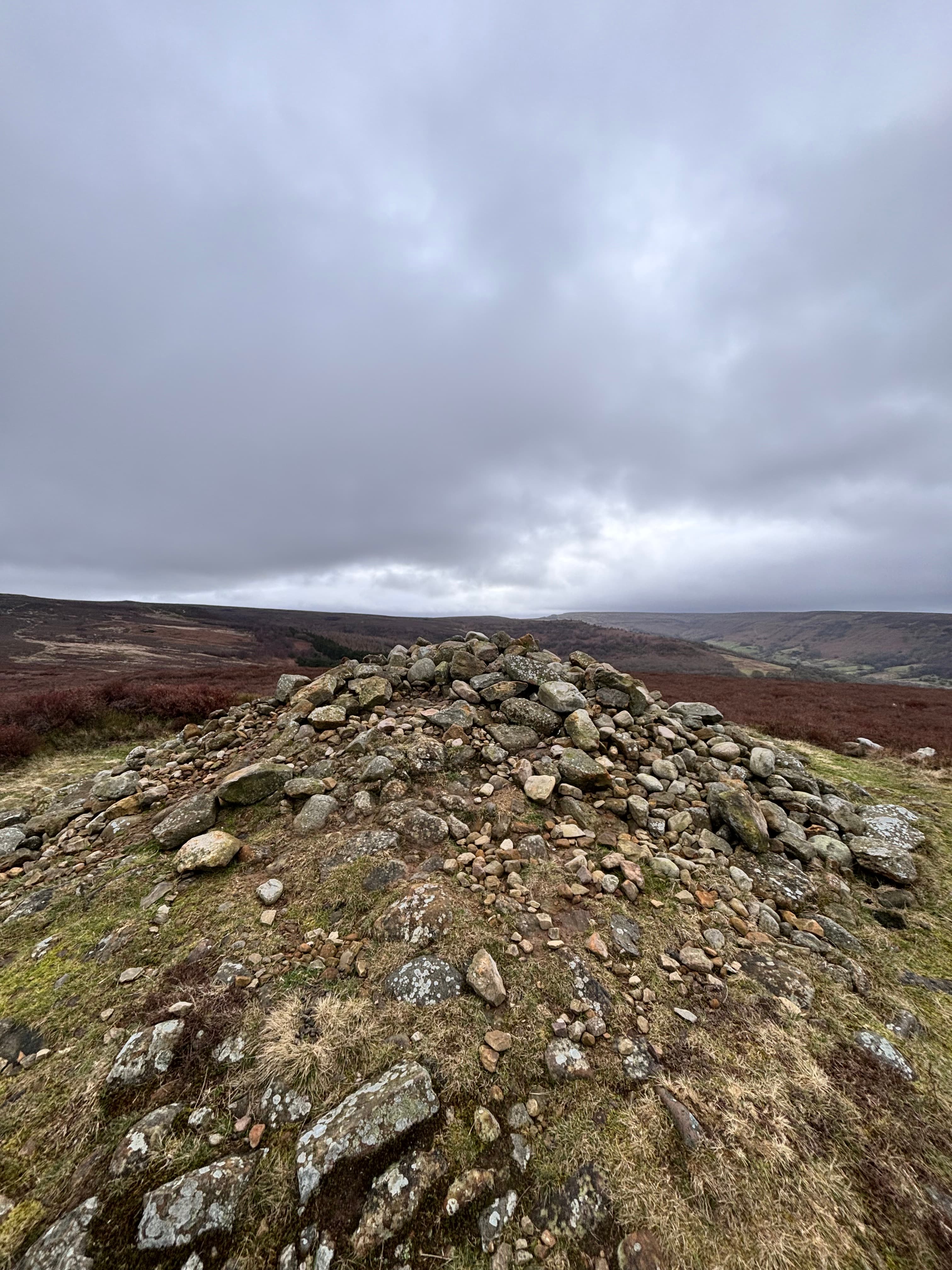 Rocky cairn on moorland under cloudy sky in Yorkshire Dales