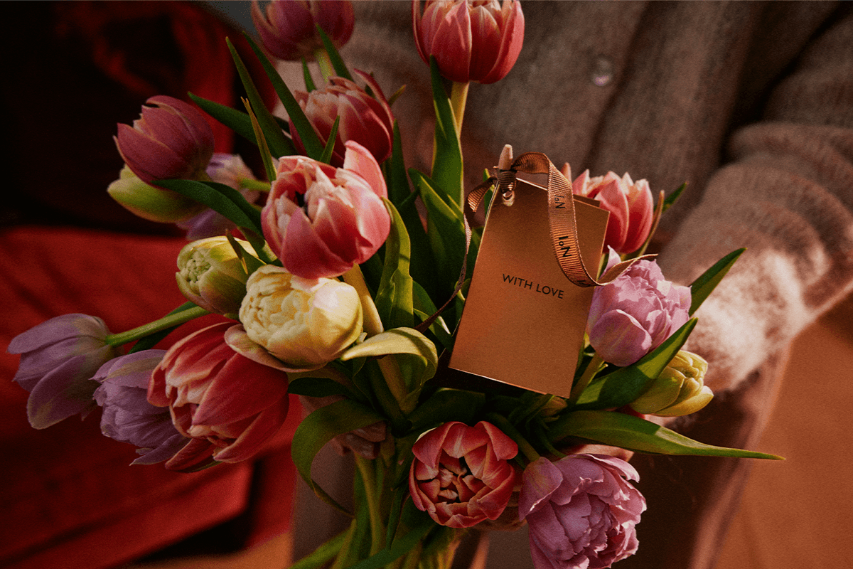 Bouquet of pink, yellow, and purple tulips with a gift tag