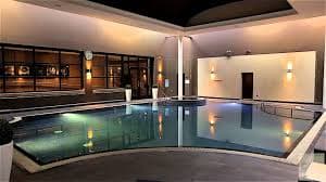 Indoor heated swimming pool with ambient lighting