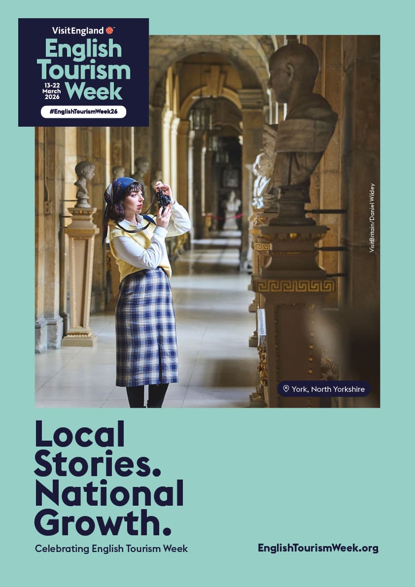 Woman photographing historical statues in York gallery
