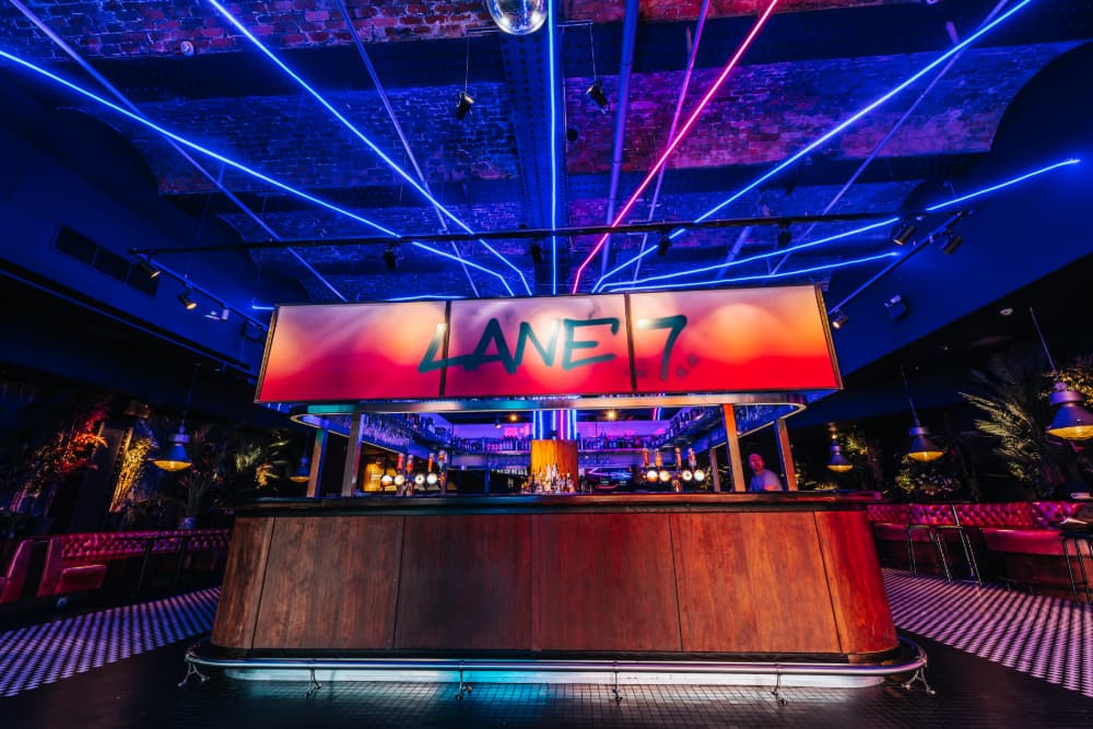 Trendy bar with neon lights and illuminated ceiling