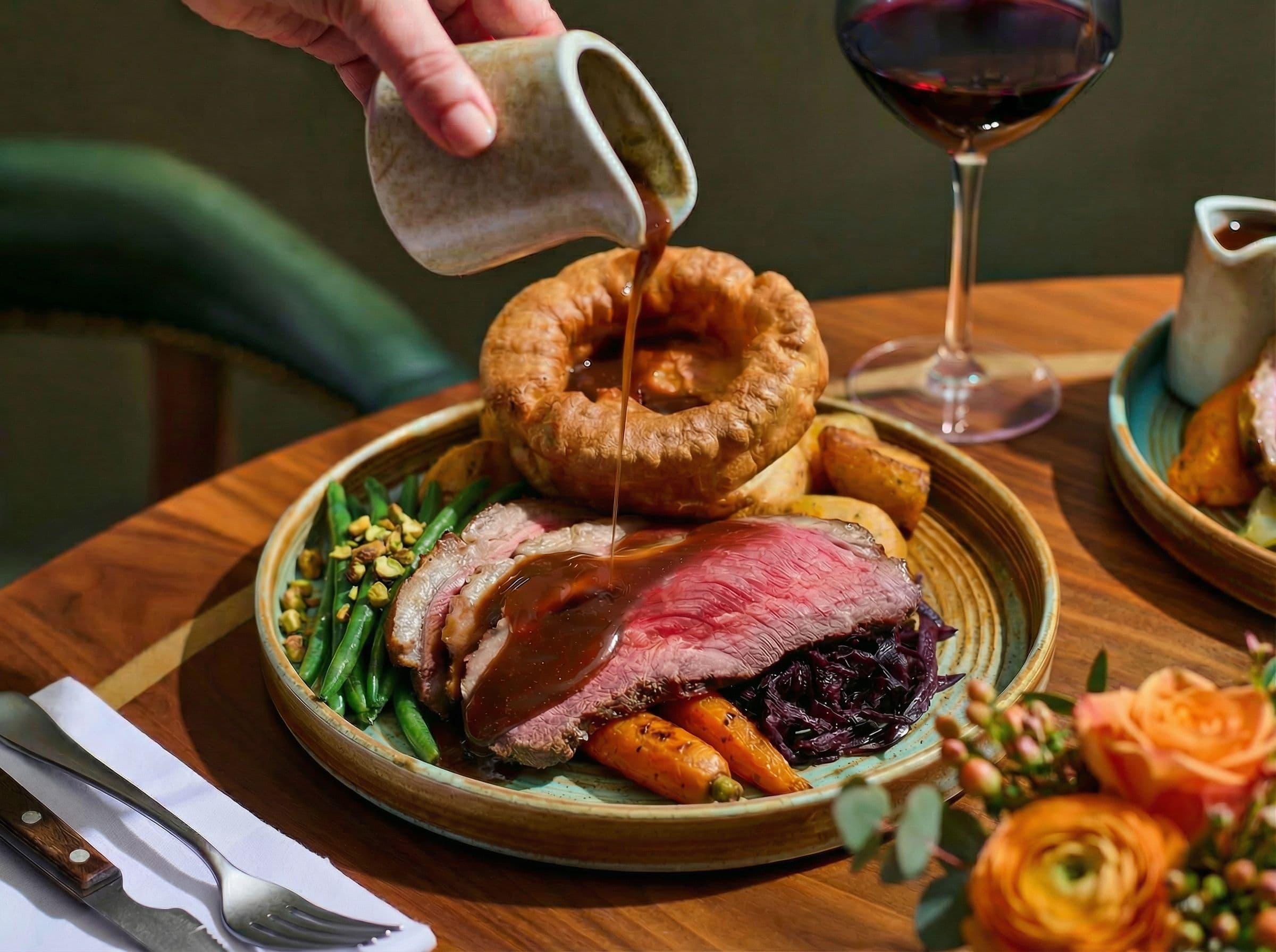 Traditional Yorkshire roast beef dinner with gravy pouring