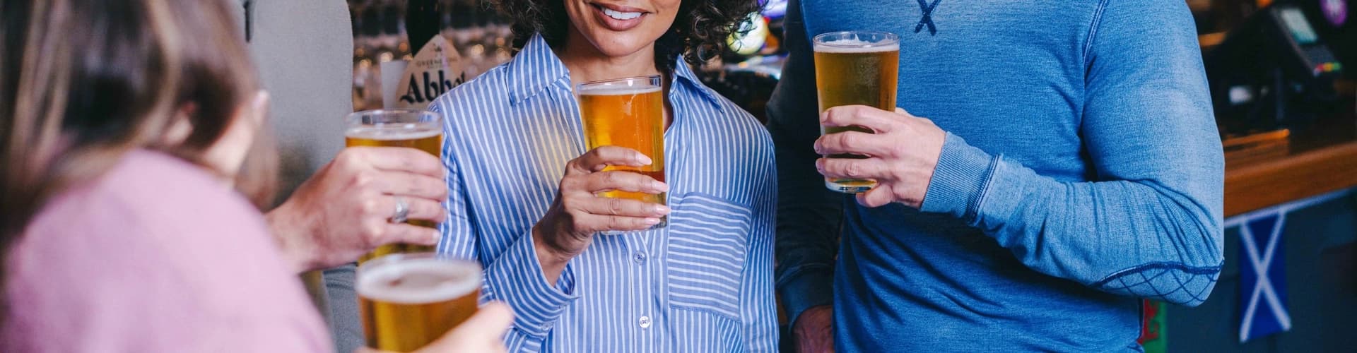 Group of people enjoying pints in a cozy Yorkshire pub
