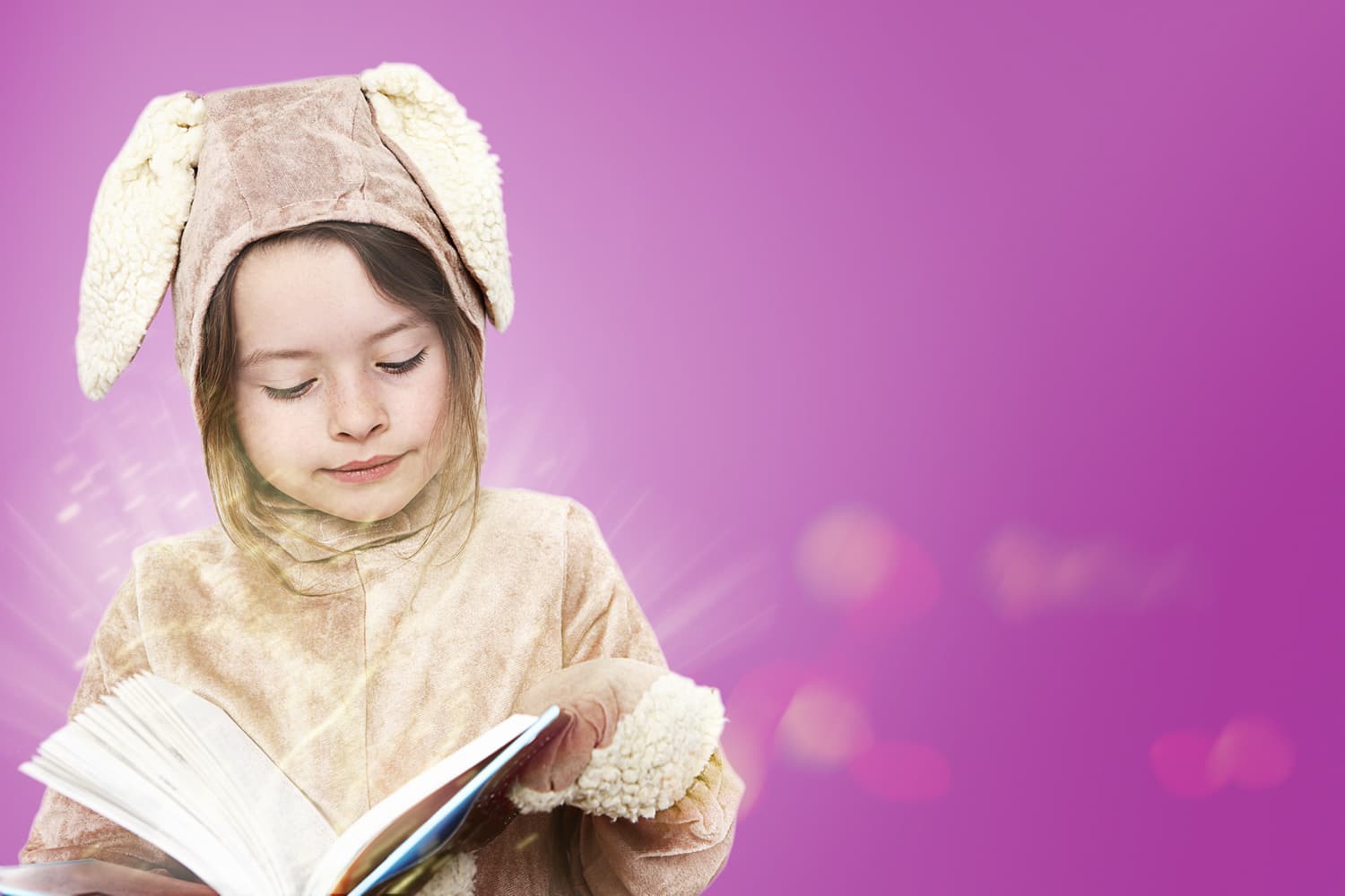 Girls in fancy dress reading a book
