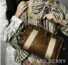 Two women in patterned clothing holding a brown and beige striped handbag, showcasing fashion accessories.