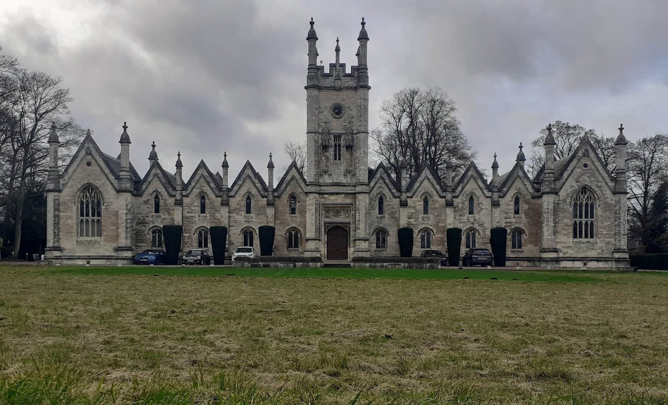 Victorian-style building with pointed arches, a central tower, and a grassy foreground in Aberford, Yorkshire.