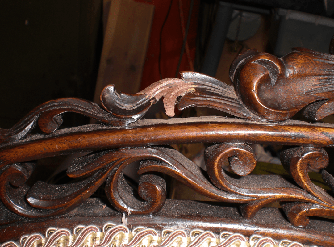 Intricate wooden carving with ornate floral designs on a furniture piece, showcasing craftsmanship in Ainderby Steeple.
