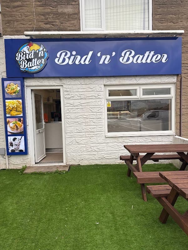 Restaurant sign "Bird 'n' Batter" with outdoor seating and a green lawn in Alverthorpe, Yorkshire.