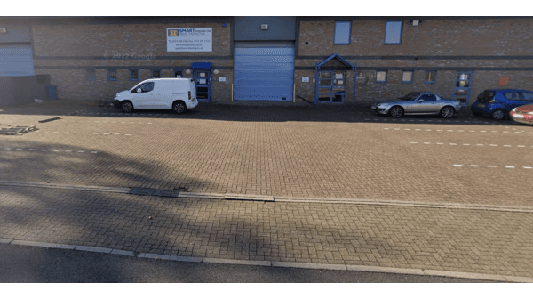 Pay & Display parking area in Attercliffe, Yorkshire, with a white van and a silver car parked alongside a brick building.