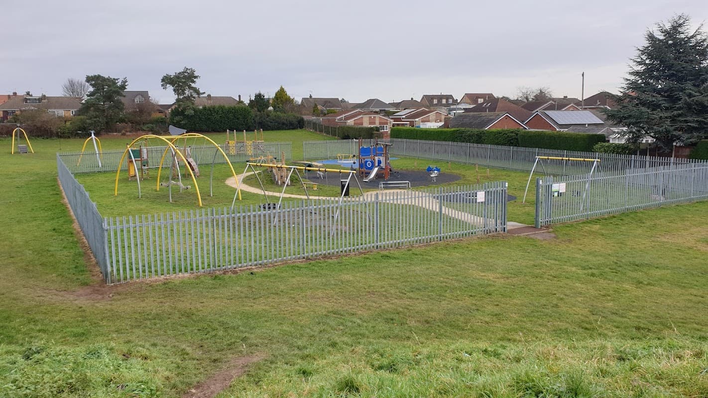 Playground with swings, climbing equipment, and a fenced grassy area in Barnby Dun, Yorkshire.