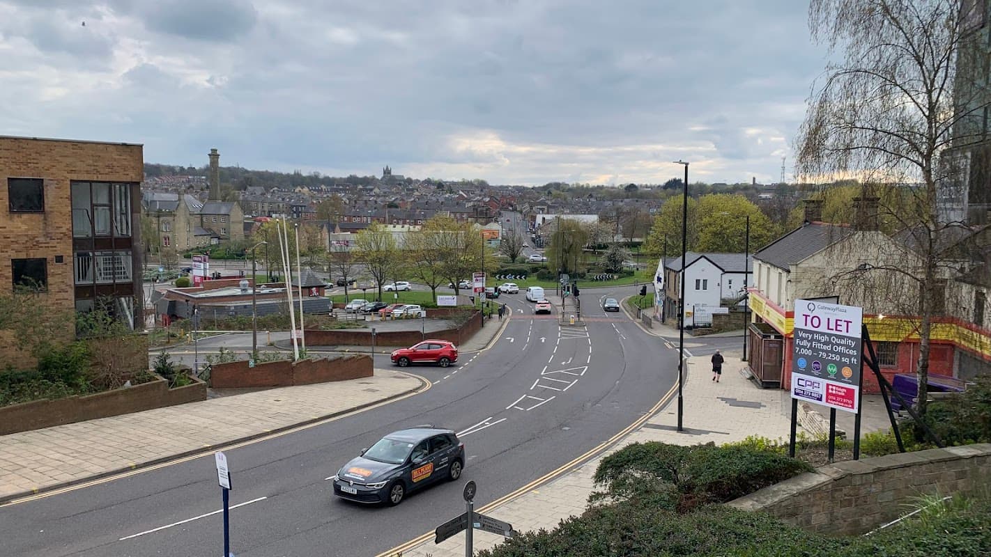 View of Gateway Plaza Car Park with cars, buildings, and a sign indicating "To Let" in Barnsley, Yorkshire.