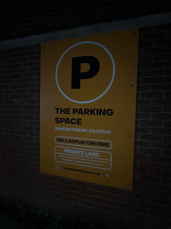 Bright yellow sign with a large "P" indicating a pay and display car park, labeled as private land.
