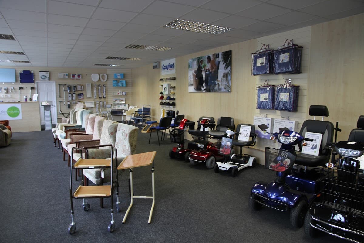 Showroom interior with mobility scooters, chairs, and mobility aids displayed on shelves and walls.