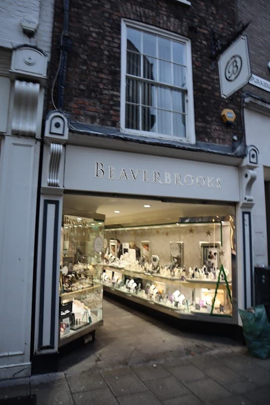 Beaverbrooks jewellers storefront in Beeston, showcasing elegant jewelry displays and a classic brick facade.