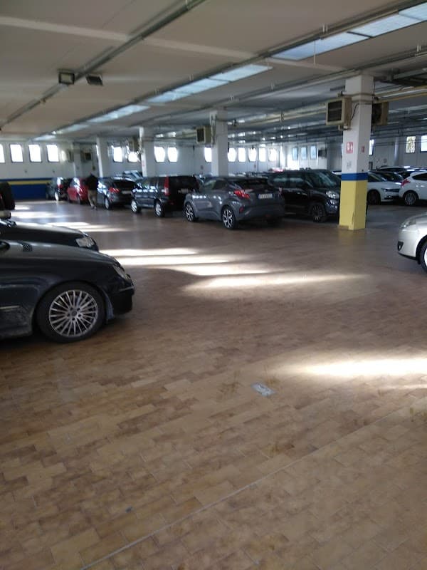 Pay & Display parking area in Beeston, Yorkshire, with multiple parked cars and bright overhead lighting.