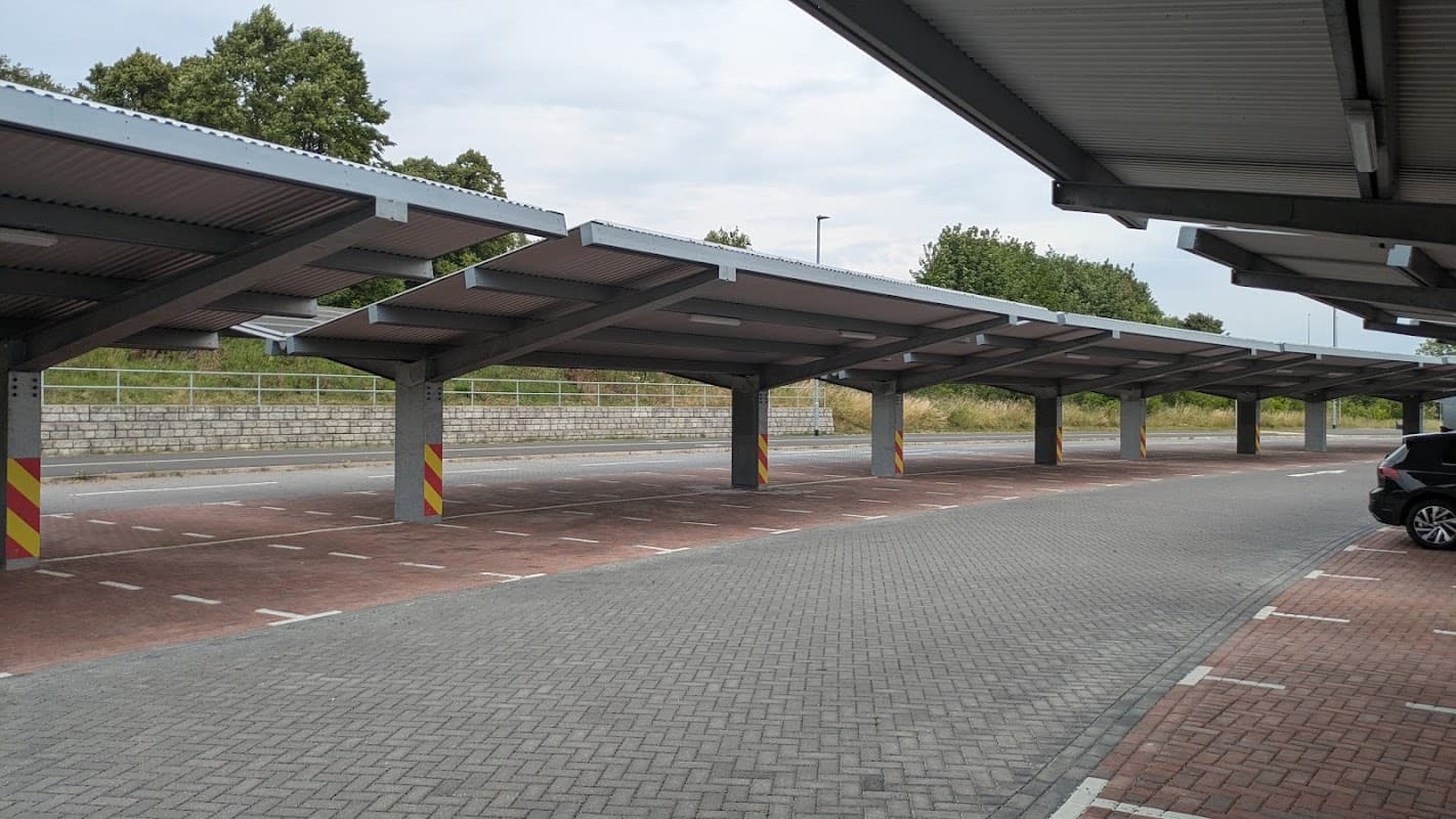 Covered parking spaces in Stourton Park & Ride, with empty bays and greenery in the background.