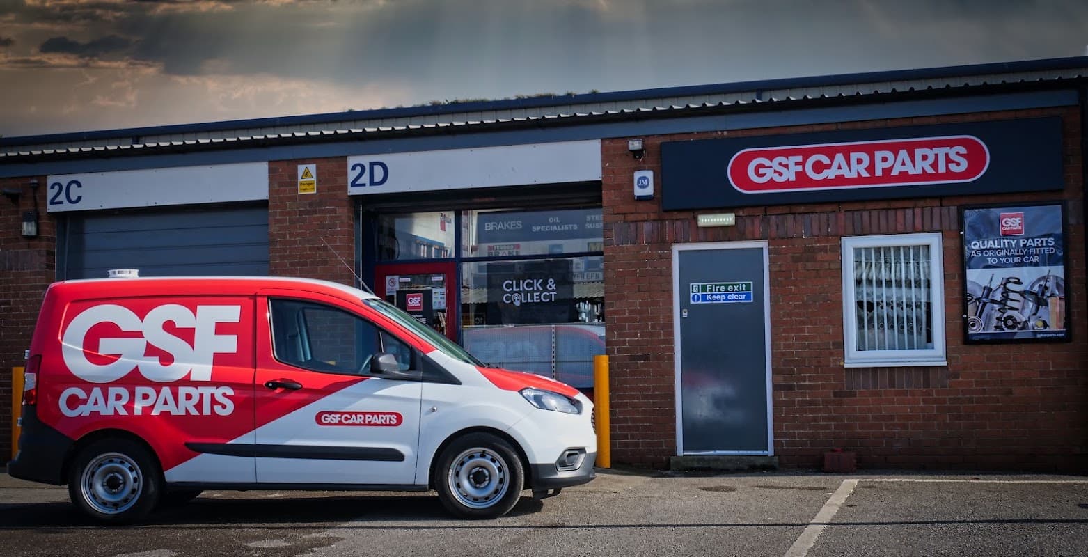 GSF Car Parts building with a red delivery van parked outside, showcasing the company logo and signage.